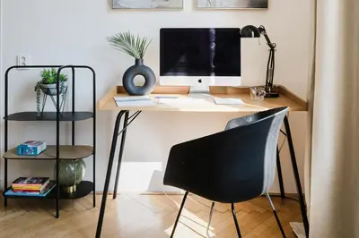 a desk with a computer monitor and a chair at Prague Days - One-bedroom Apartment with Netflix and Workspace with iMac in New Town in Prague