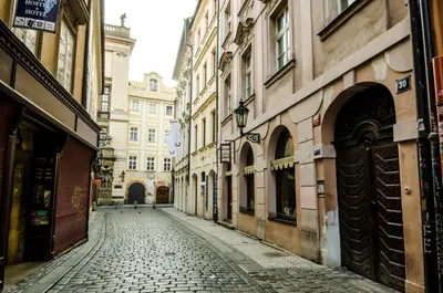 an empty street in a city with buildings at Wishlist Prague Residences - Charles Bridge Karlova in Prague