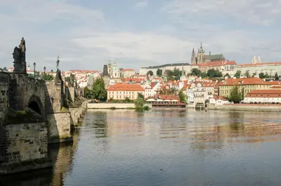 a view of a city with a bridge and a river at Wishlist Prague Residences - Charles Bridge Karlova in Prague