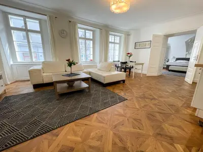 a living room with a couch and a table at U Obecního dvora - Old Town Apartment in Prague