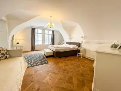 a large room with a bed and a window at U Obecního dvora - Old Town Apartment in Prague
