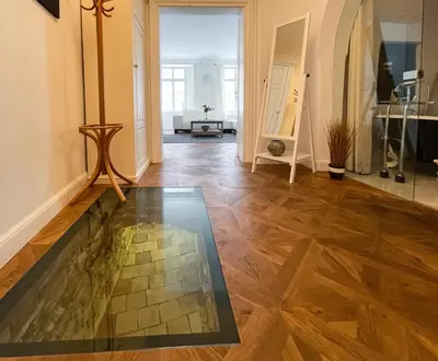 a hallway with a glass floor in a building at U Obecního dvora - Old Town Apartment in Prague