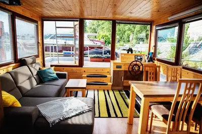 a living room with a couch and a table at Houseboat Bonanza Prague in Prague