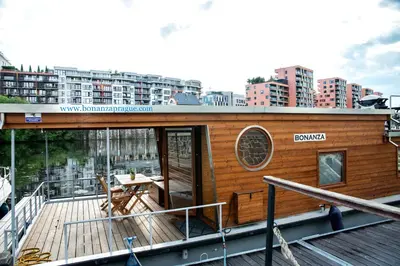 a wooden deck with a table on a boat at Houseboat Bonanza Prague in Prague