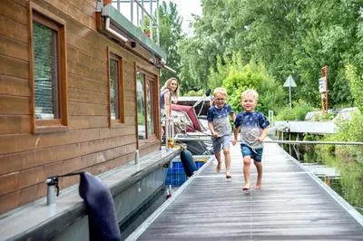 two children walking on a dock on a boat at Houseboat Bonanza Prague in Prague