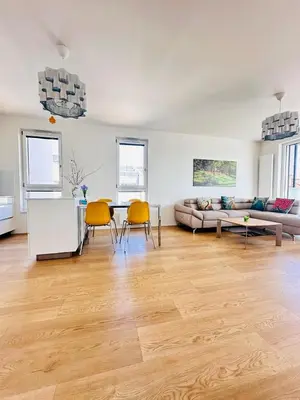 a living room with a couch and a table and chairs at Nová Nuselská in Prague