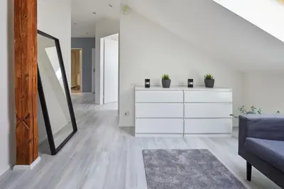 a dining room with a white table and chairs at Prague Days - Bright Apartments - Fast WiFi - Quiet Area in Prague