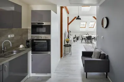 a kitchen and living room with a couch and a table at Prague Days - Bright Apartments - Fast WiFi - Quiet Area in Prague
