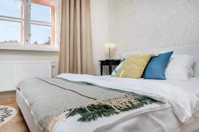 a kitchen with stainless steel appliances and wood floors at Prague Days - Bright Apartments - Fast WiFi - Quiet Area in Prague