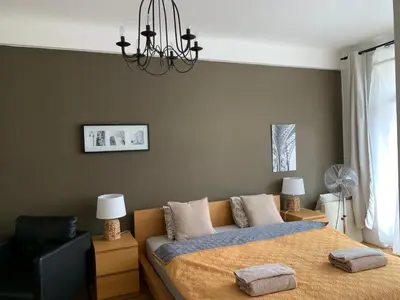a bedroom with a bed and a chandelier at Anenska by Charles Bridge 2 in Prague