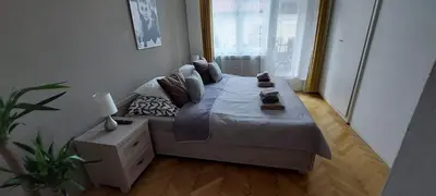 a large bed in a room with a large window at Anenska by Charles Bridge 2 in Prague