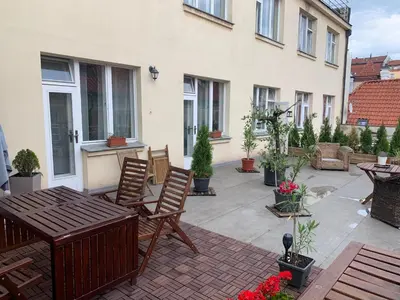 a patio with chairs and a table on a patio at Anenska by Charles Bridge 2 in Prague