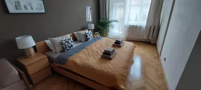 a bedroom with a bed and a couch and a window at Anenska by Charles Bridge 2 in Prague