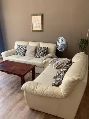 a living room with two couches and a table at Anenska by Charles Bridge 2 in Prague