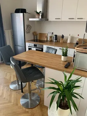a kitchen with a wooden table in a kitchen at Anenska by Charles Bridge 1 in Prague
