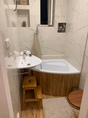 a bathroom with a white tub and a sink at Anenska by Charles Bridge 1 in Prague