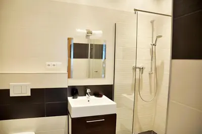 a white table with white chairs and a vase on it at Family Apartments in Prague