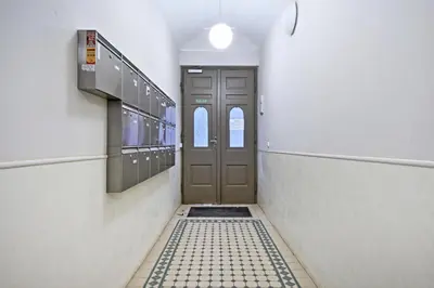a hallway with a door and a tile floor at Family Apartments in Prague