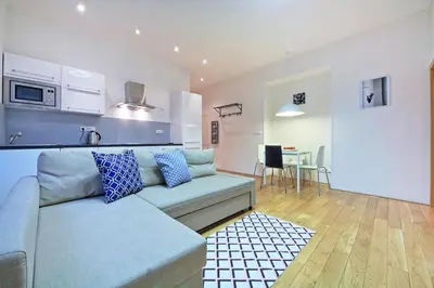 a bathroom with a washing machine and a sink at Family Apartments in Prague