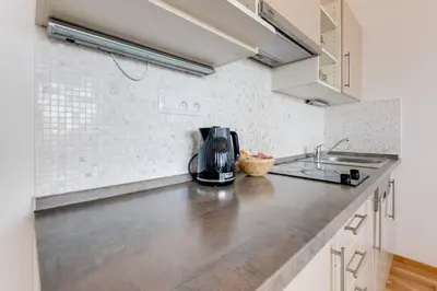 a kitchen counter with a coffee maker on it at JT's Apartments Korunní str. in Prague