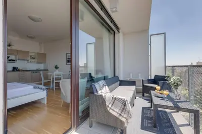 a living room with a couch and a table at JT's Apartments Korunní str. in Prague
