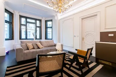a living room with a couch and a table and chairs at Antique Glam Apartment in Old Town Prague in Prague