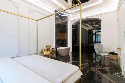 a bedroom with a bed with a gold frame at Antique Glam Apartment in Old Town Prague in Prague