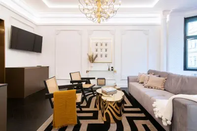 a living room with a couch and chairs and a chandelier at Antique Glam Apartment in Old Town Prague in Prague