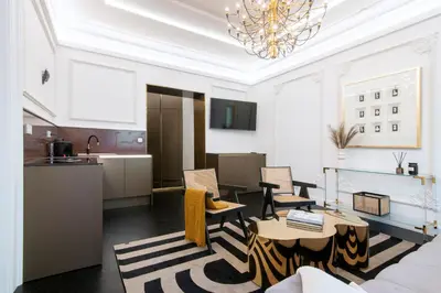 a living room with a couch and a table at Antique Glam Apartment in Old Town Prague in Prague