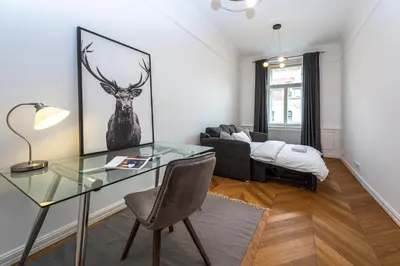 a living room with a glass table and a couch at Wishlist Prague Residences Malá Strana in Prague