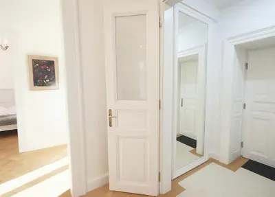 a white door in a room with a mirror at Wishlist Prague Residences Malá Strana in Prague