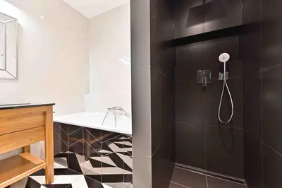a bathroom with a shower and a sink at Wishlist Prague Residences Malá Strana in Prague