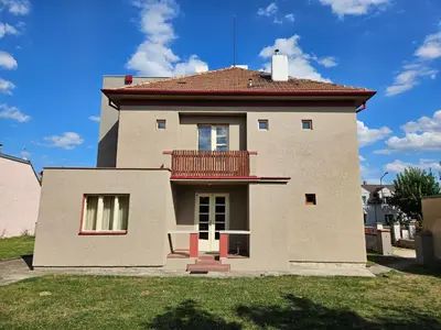 a house with a balcony on top of it at Rodinný dům pod Hazemburkem in Libochovice
