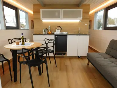 a kitchen and living room with a table and chairs at Hausbót na Vltavě in Hradištko