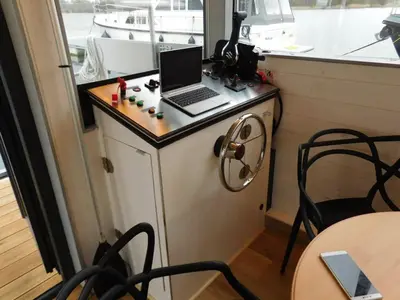 a table with a laptop computer on top of it at Hausbót na Vltavě in Hradištko