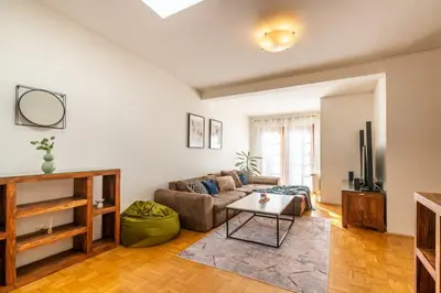 a living room with a couch and a table at Templová - Old Town Large Apartment with Terrace in Prague