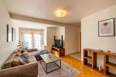 a living room with a couch and a tv at Templová - Old Town Large Apartment with Terrace in Prague
