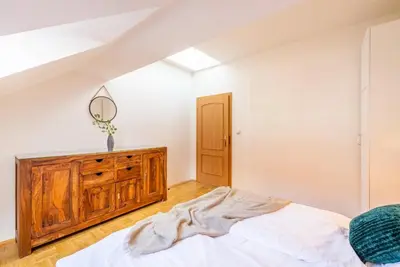 a bedroom with a bed and a wooden dresser at Templová - Old Town Large Apartment with Terrace in Prague