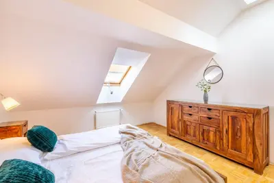 a bedroom with a bed and a wooden dresser at Templová - Old Town Large Apartment with Terrace in Prague