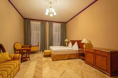 a hotel room with a bed and a couch at 4 Bedrooms 130m2 apartment at the Main City Square in Prague