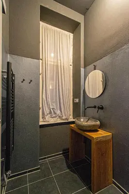 a bathroom with a sink and a mirror at 4 Bedrooms 130m2 apartment at the Main City Square in Prague