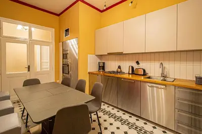 a kitchen with a table and chairs and a sink at 4 Bedrooms 130m2 apartment at the Main City Square in Prague