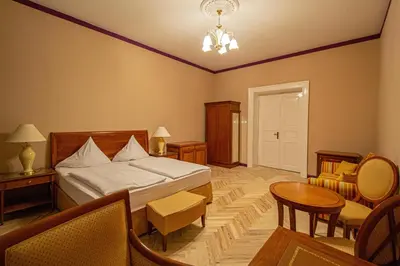 a bedroom with a bed and a table and chairs at 4 Bedrooms 130m2 apartment at the Main City Square in Prague