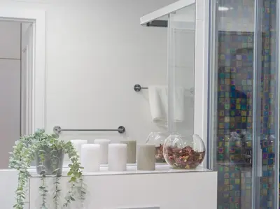 a white room with a shelf with candles and a mirror at BARTAL APARTMENTS - Prague in Prague