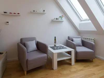 two chairs and a table in a attic at BARTAL APARTMENTS - Prague in Prague