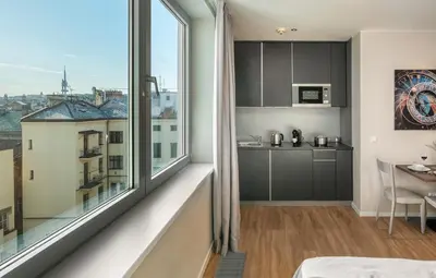 a room with a large window and a kitchen at VN17 Rooftop Suites by Adrez in Prague