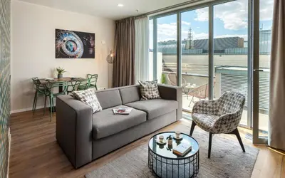 a living room with a couch and a table at VN17 Rooftop Suites by Adrez in Prague