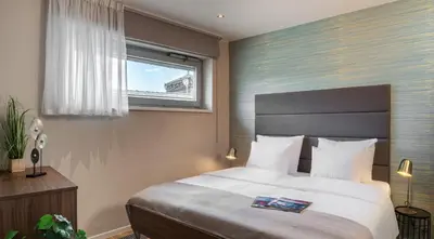 a bedroom with a large bed and a window at VN17 Rooftop Suites by Adrez in Prague