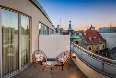 a balcony with chairs and a view of a city at VN17 Rooftop Suites by Adrez in Prague