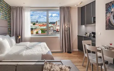 a hotel room with a bed and a kitchen at VN17 Rooftop Suites by Adrez in Prague
